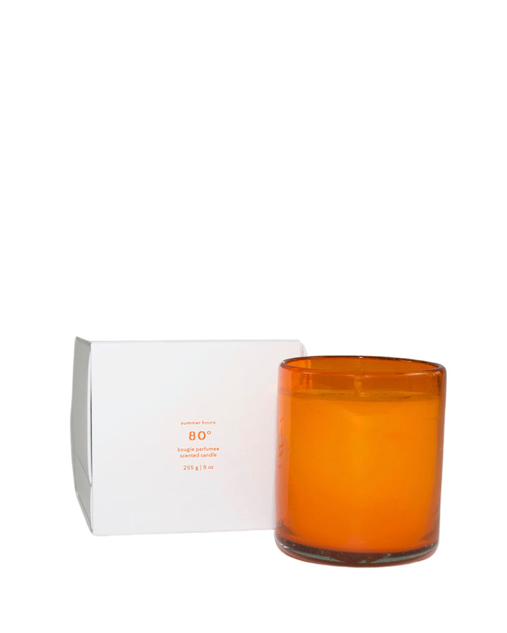 Summer Hours 80° candle in an orange glass and box on a white background